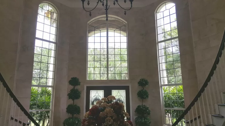 Tall arched windows in a two-story entryway after professional window cleaning